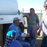 A smiling Bob at the airport, with others congratulating him for his accomplishment.