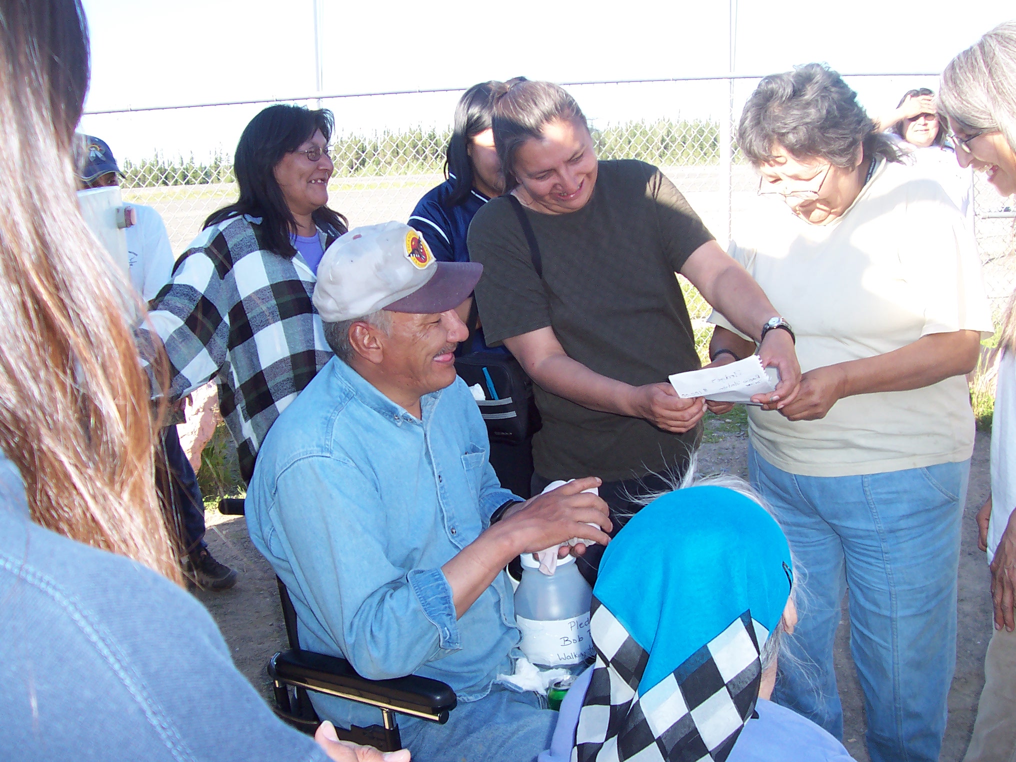 Philomena Meekis, and Julie Meekis, looking at the list of pledges that was received today for Bob.