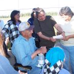 Philomena Meekis, and Julie Meekis, looking at the list of pledges that was received today for Bob.