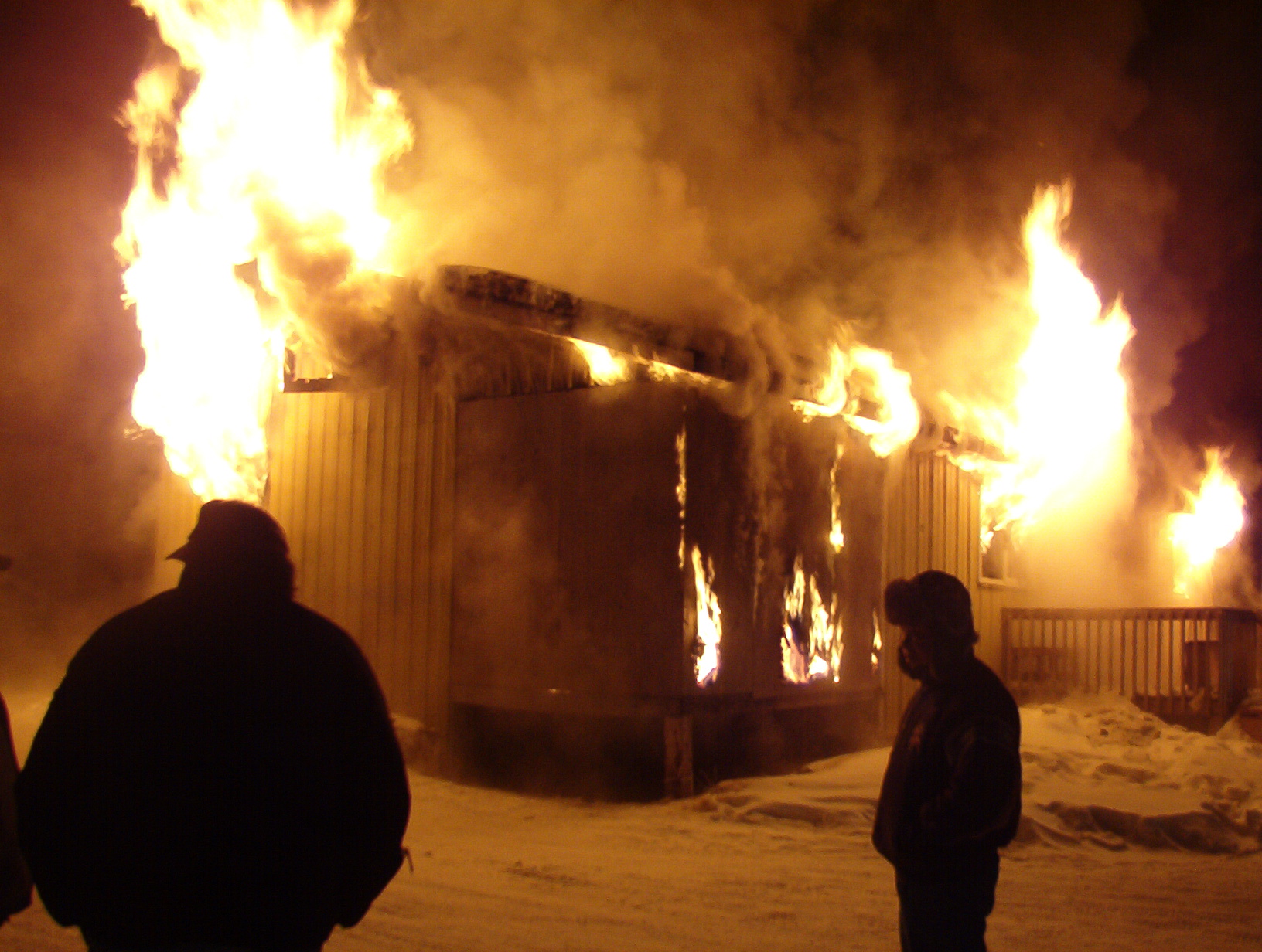 more community members stand by the flames