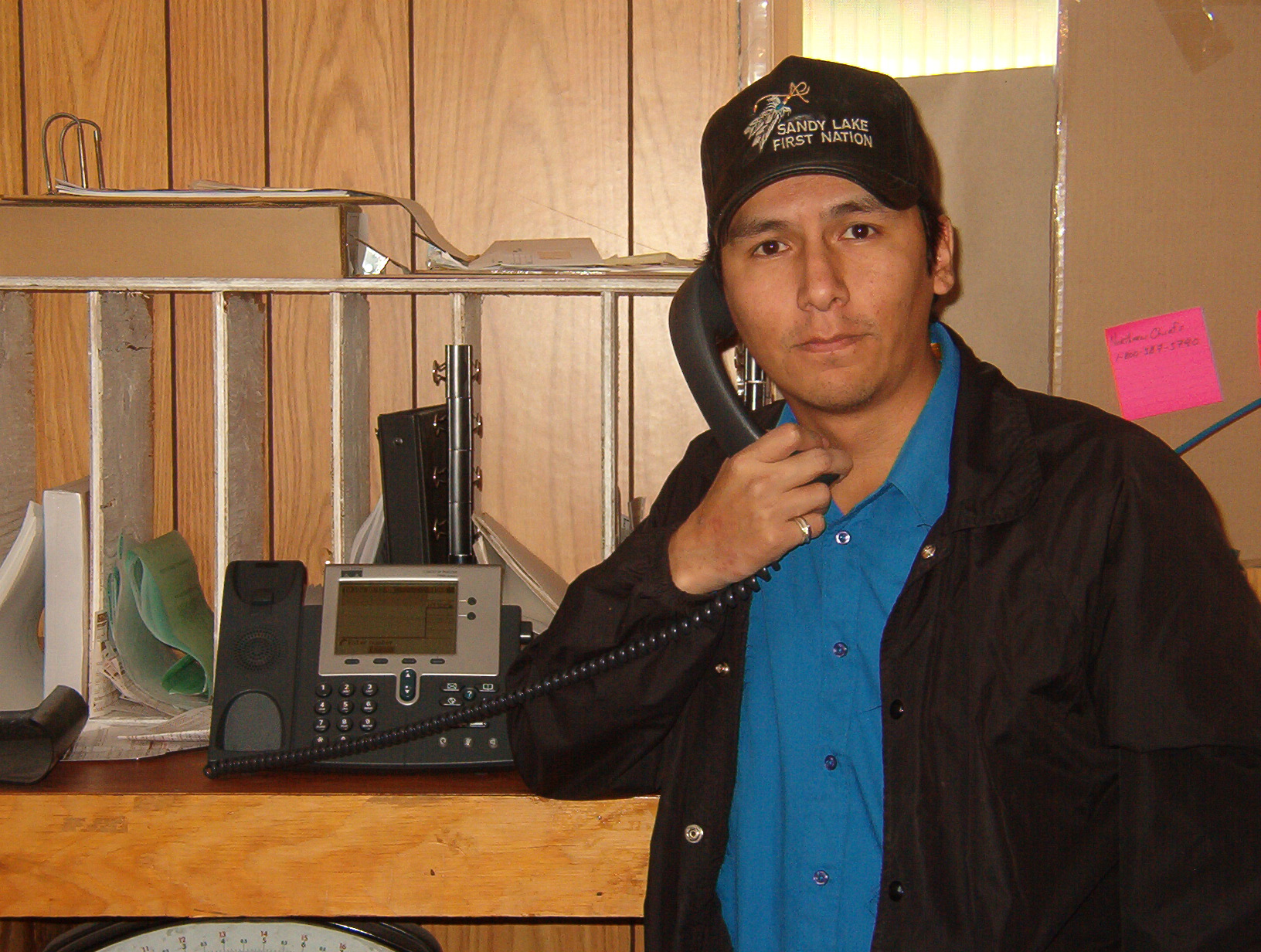 Shayne Rae, Post master for the Band Office, poses for a picture with his IP phone.