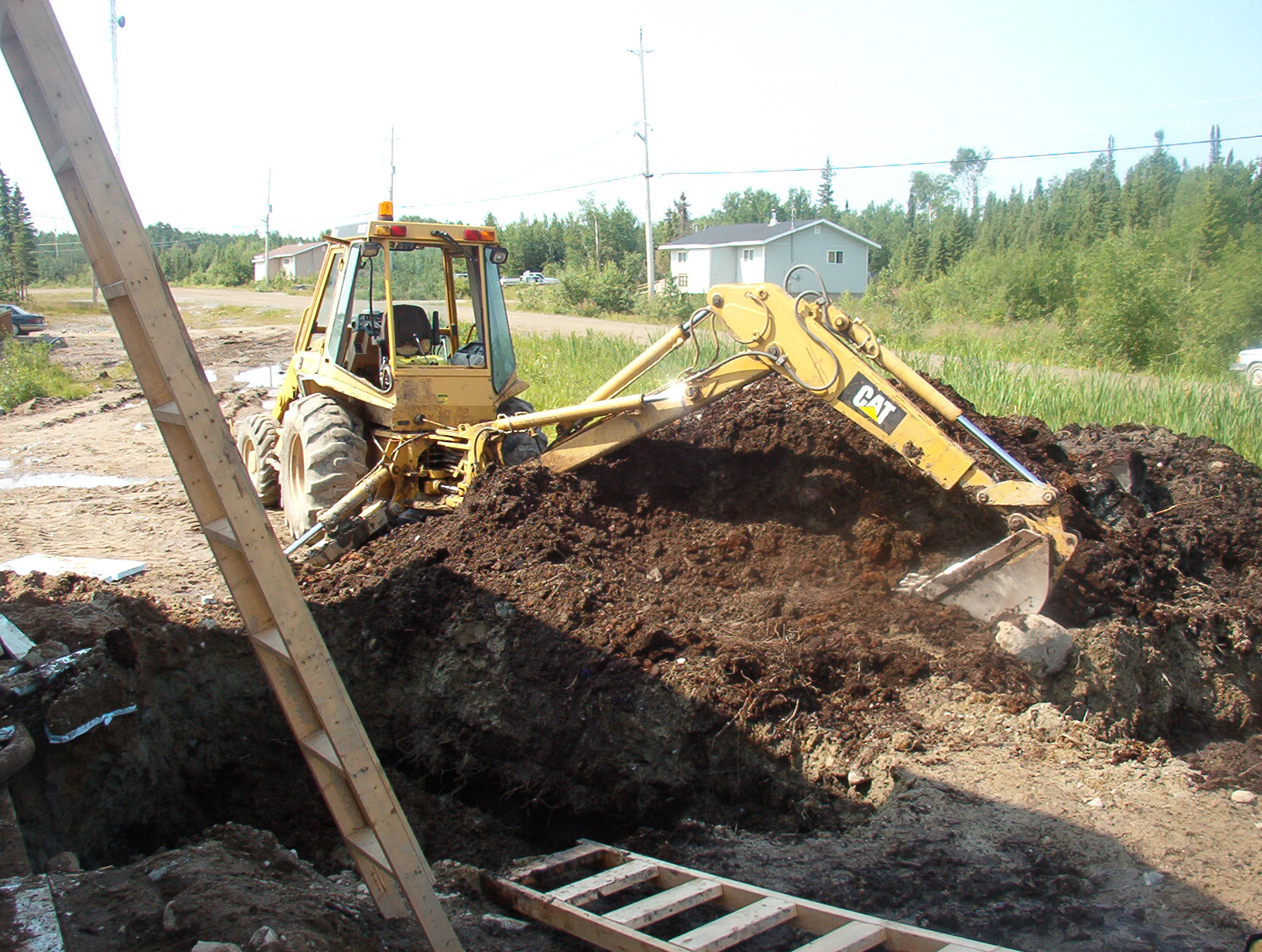 The tractor that is being used, to dig the ground to place the pipes in.