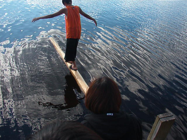 Tyler Meekis, practising for the walking log contest.  With is practices, he was one of the winners for seventy five dollars.