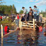 Not sure who is standing in the water, but Morris Rae, is starting to climb down onto the log.