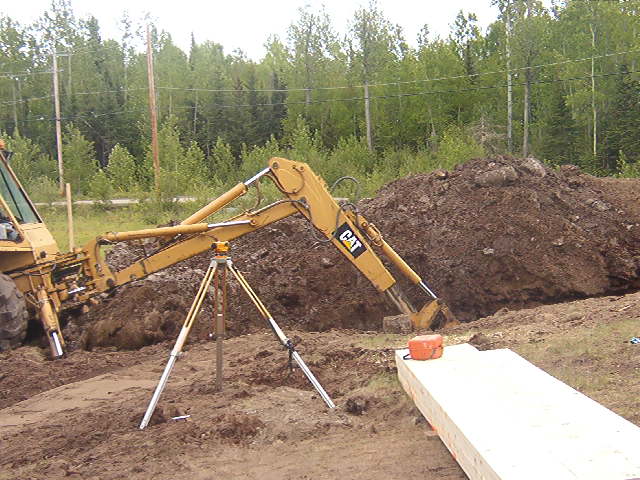 Back hoe, digging into the ground.