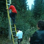 Darlene watches as Brian and Oscar do some technician work.