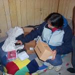 Darlene unpacking the cable modem at Patrick Kakegamick's place.